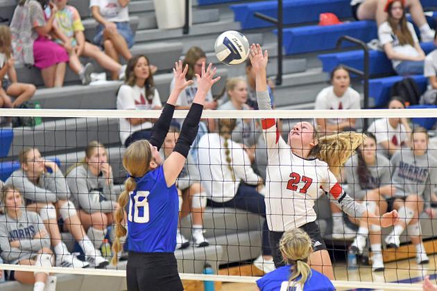 Aurora’s Kasey Schuster tips the ball over the net during the Lady Huskies’ three-set win over Wahoo Thursday. 