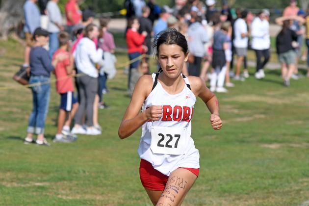 Alexis Ericksen pushes through to a third place finish at the Aurora Invite on Friday, earning top freshman honors of the event.