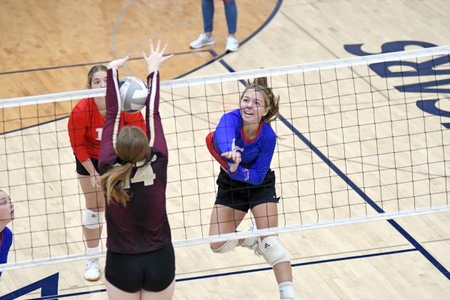 HPC’s Hailey Lindburg powers an attack through the East Butler defense during a three-set win over the Tigers Saturday. 