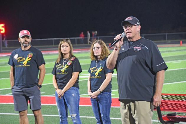 Gary Peters speaks to Friday’s home football crowd, seeking support for the Pediatrict Cancer Action Network. Joining Peters on the track were his wife, Shari,  Nicole Broman and Nick Owens, all of whom lost a child to pediatric cancer.