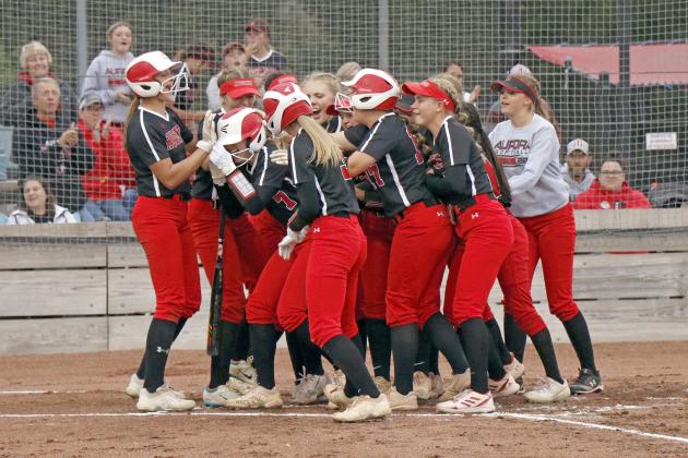 The Aurora bench mobs Eva Fahrnbruch at the plate after her two-run homer in the first inning of a 6-5 loss to Columbus Lakeview on Senior Night Thursday. 
