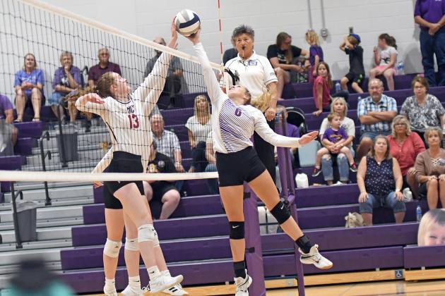 Raegan Hansen gets into a hand fight at the net during Hampton’s three-set loss to Heartland. Hansen tallied 25 set assists in the match. 