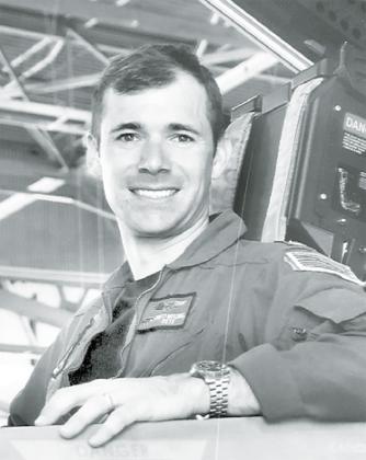 U.S. Navy pilot Lieutenant Brett Mitchell shoots a smile inside a cockpit. Mitchell will give details of his life and the facts of “Top Gun: Maverick” in a fundraising event for Heroes and Huskies Sunday afternoon.