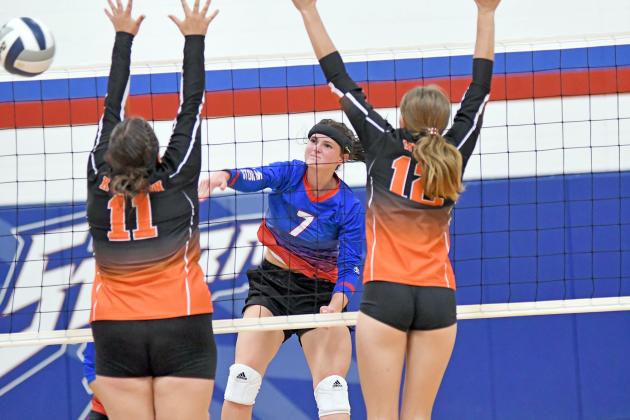 HPC’s Kenzie Wruble smashes an attack past the Giltner defense of Kailyn Wilson (left) and Tracy Wiles during the Storm’s two-set win over the Hornets Thursday. 
