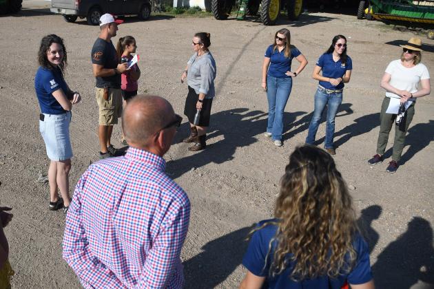 Farmer Zach Hunnicutt (third from left standing next to daughter, Adeline) discusses technology and other areas of his farm with an assembled crowd of NASA’s Earth Science Division members, UNL Extension agents and media.