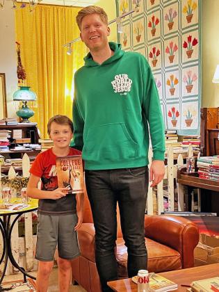 Courtesy Photo Chad Rykhoek poses with Shaun Williams at the book signing event at Susan’s Books and Gifts on Oct. 12. Rykhoek stated he hopes his story is inspiring to young athletes. 