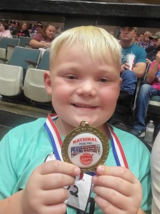Liam Faller was all smiles showing off his National Pedal Pull Championships medal in South Dakota this September. He said he had a good time.