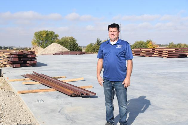 Jason Friesen, owner of Friesen Ford in Aurora, stands on the cement foundation where a new parts distribution warehouse will be built to the north of the dealership. He hopes the facility will be completed “before the snow flies.”