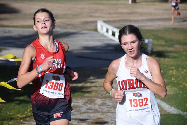 Ella Eggleston begins to pass Adams Central runner  Catharine Lehn during the last leg of the race. Eggleston finished third in the race as Aurora took runner-up as a team. 