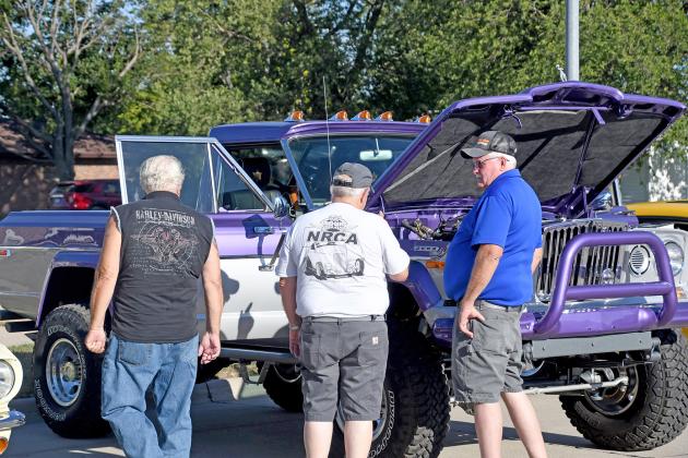Tom Granfield, right, takes a few onlookers on a tour of his 1978 Jeep Gladiator at this year’s TLDC Cruise Night. Granfield, raised in Hampton, has deep connections to the town due to his father, Daryl Granfield, owning the Korner 9 Klub.