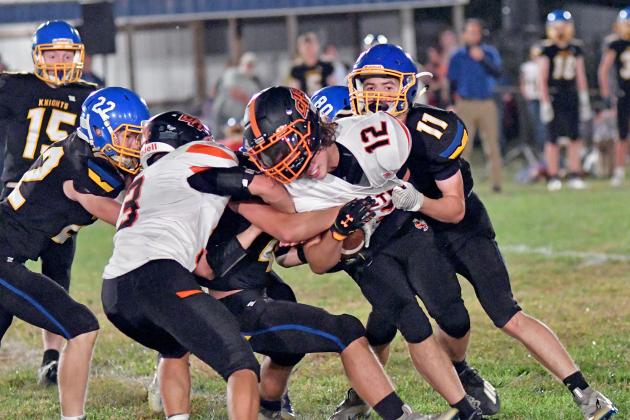 Giltner’s Blaydon White fights for extra yards after a tug on his helmet in a 64-36 loss to Nebraska Lutheran Friday. 