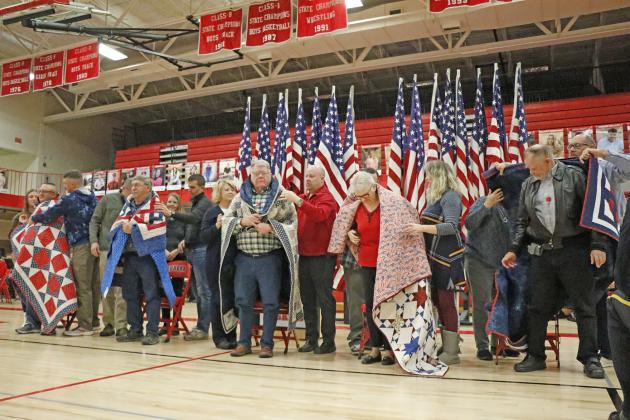 Five local veterans were awarded their Quilt of Valor during last week’s Veterans Day program at Aurora High School. They were wrapped in their quilts by members of their family. These individuals included, from left: Scott Springer, John Springer, Dick Phillips, Pat Nuss and Leon Cederlind. 