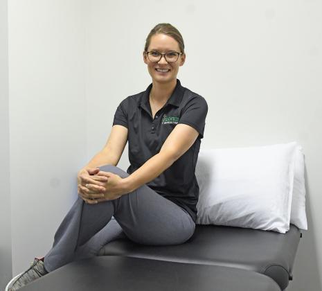 Physical therapist Carlee Hawkins on her bed in her office located at Esslinger Physical Therapy. Hawkins opened her business to focus on lymphedema and women’s pelvic floor treatments.