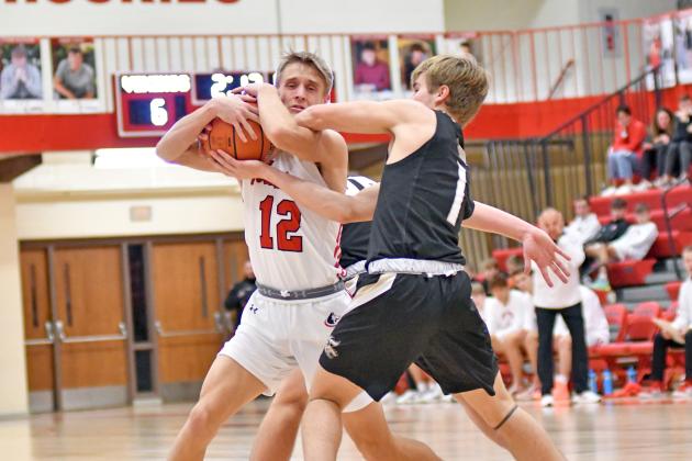 Carsen Staehr wins a tie-up in the first half of Aurora’s 55-31 win over GINW Saturday. Staehr led the way with 18 points. 