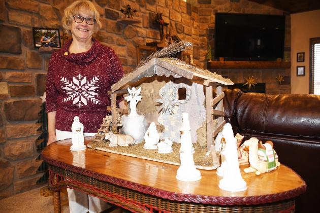 Jane Nunnenkamp shows the Nativity set she bought just after her marriage to Larry in 1971, adding figures to the display. Since then she has collected 25 more Nativity scenes.