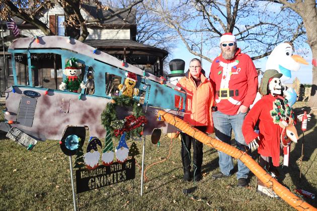 Dawn and Rusty Ogden stand by an RV with sewer pipe and skeletal Cousin Eddie from “National Lampoon’s Christmas Vacation” as well as the “Hanging with my Gnomies” sign won last year Hampton’s Annual House Decorating contest. A second place winner this year in the Hampton Christmas decorating contest, Rusty enjoys the work and community appreciation that comes with his decorations.