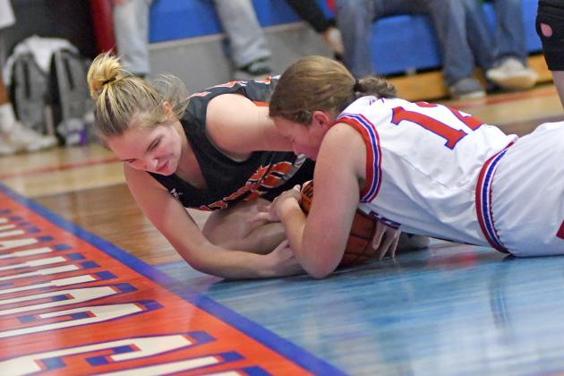 Giltner’s Hailey Eastman gets tied up with HPC’s Allie Howell on the baseline.