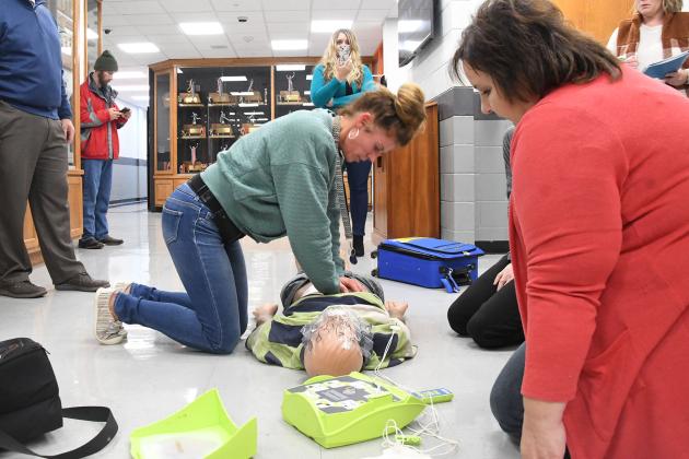 From left to right, teacher and coach Nancy Lockmon, Principal Chris Pietrzak, Hamilton County deputy sheriff Drew Scott, counselor Ashley McCarter and paraeducator Karissa Bish observe and take record as teacher Dani Trosper performs CPR and preschool teacher Amy Wilson stands by to deliver shocks by automated external defibrillator. The members of the Emergency Response Team took turns with CPR in order to continue the quality of the action for the drill for Project ADAM Heart Safe program. 