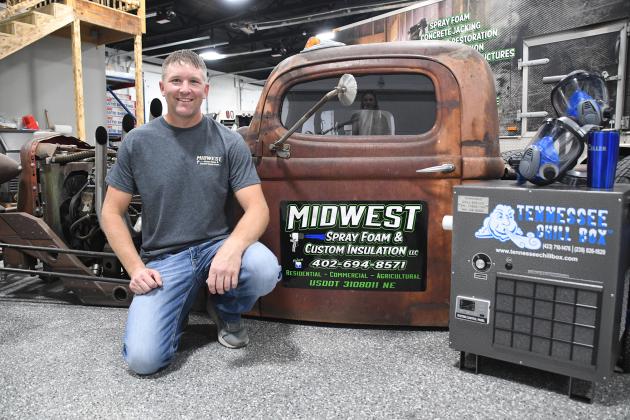 Eric Joseph was named runner-up for the Contractor of the Year award from SprayFoam magazine. He poses here with his hotrod, which originally was a white semi truck for Anheuser-Busch, along with two of his prizes.