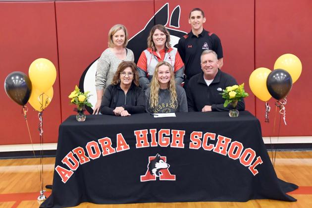 Kasey Schuster signed her letter of intent to Nebraska Wesleyan Jan. 11 alongside her parents, Scott and Dara, as well as Aurora’s former volleyball coach Lois Hixson and current coaches Rachelle Kruml and Andrew Murillo. 