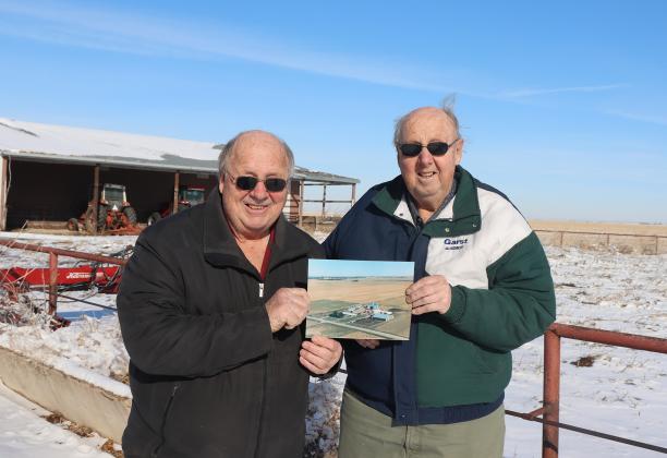 Former livestock producers Philip (left) and Ralph Ratzlaff hold a photo of their beef operation which began in the early 1970s. The brothers dispersed their operation two years ago, but still remain respected among the cattle industry. Ralph will be an honored guest of this year’s York/Hamilton Cattlemen’s Banquet.