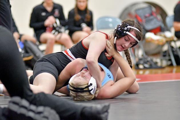 Paityn Wyatt rips a takedown, one of multiple she had in her match, which included a pinfall victory during Aurora’s dual win over Columbus Lakeview at home Thursday. 