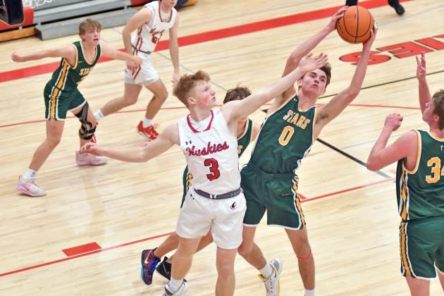 Aurora’s Drew Knust battles for an offensive board during Aurora’s 52-23 win over Kearney Catholic. 
