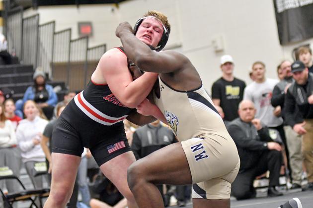 Jack Allen wrestles for position with GINW’s Victor Isele during their fourth match of the season Saturday in the district championship match. Allen was victorious, and has been on all four occasions this year. 