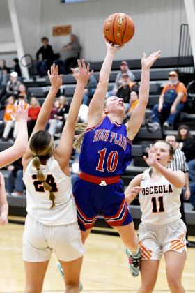 High Plains senior Hailey Lindburg drives the lane and puts up a shot between two Osceola defenders during Thursday’s subdistrict final, which the Lady Storm lost in overtime, 43-38.