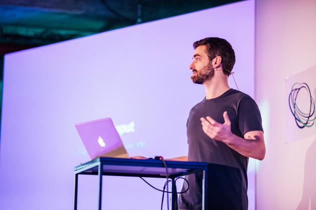 Jay Phelps speaks in 2019 at ReactiveConf in Prague. Phelps has help found two businesses still in operation, and worked throughout the tech world without a college degree.