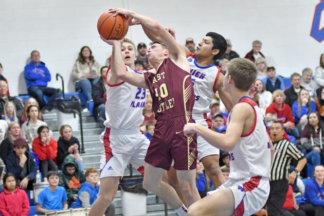 HPC’s Brodey Spurling (23) and Raul Marino (behind) make the shot difficult while Carter Urkoski comes to guard from the front in the Storm’s 60-52 win Friday. 