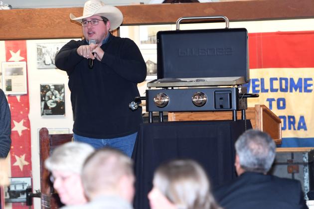 Auctioneer Jamie Bergmark calls for bids during Monday’s night’s auction at the Plainsman Museum, which drew a large crowd.