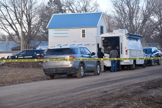 Crime scene tape surrounds the Adams home in Marquette Sunday as law enforcement begins homicide investigation.