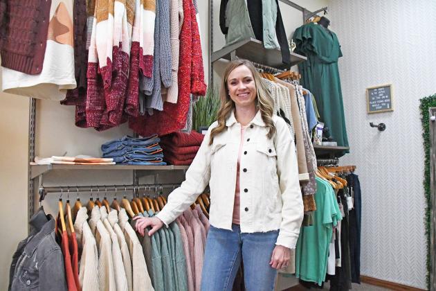 Heather Keasling, who co-owns Lilie Jack Boutique with her husband, Derek, displays some of the women’s clothing inventory in their new location.