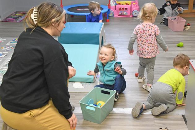 Kids, including Rylee Critel at the center, help Littler Stingers staff member Addy Petzoldt with cleanup after playtime. The Little Stingers Childcare Program now occupies two buildings to house different age groups of preschoolers.