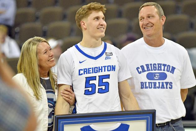 Baylor Scheierman, flanked by his parents, Shannon and Scott, watch the CHI video board as it plays a tribute to the Creighton senior March 1 after the Jays defeated Georgetown, 99-59. 