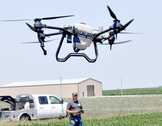 Randy Jensen at the controls of his new commercial ag drone. Jensen can apply chemical, fertilizer or seed to up to 40 acres in an hour with the drone. 