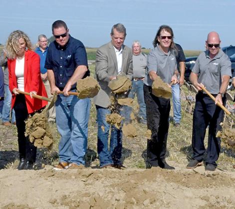 Nebraska Gov. Jim Pillen, center, demonstrates that he still knows how to handle a shovel at the Mission Critical groundbreaking Aug. 11 in Aurora. Pillen told the crowd at the ceremony Nebraska agriculture has a bright future. 
