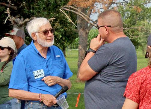Grain Place Foods CEO David Vetter, left, visits with an attendee at the organization’s annual Field Day on July 15.  