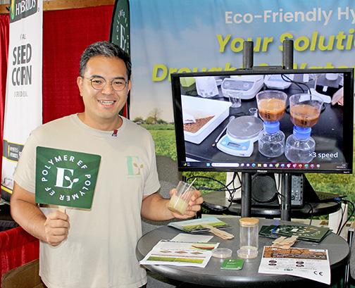 Kuni Shimoji, COO of Japan-based EF Polymer, shows off his product at the company’s booth at this year’s Husker Harvest Days. The product made from discarded orange and banana peelings promises to hold moisture in the soil and boost yields. 