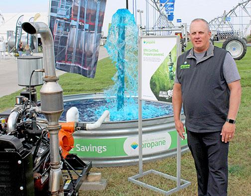 Mike Newland, who serves as the director of agriculture business development for the Propane Education and Research Council, stands next to the council’s display at Husker Harvest Days. 