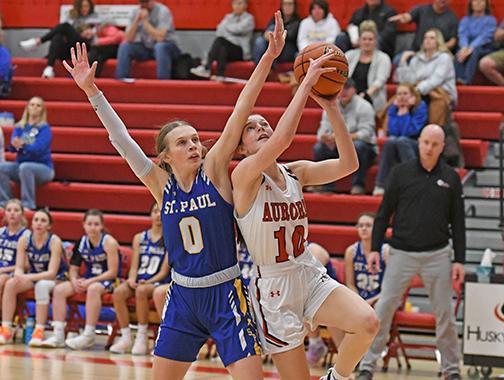 Aurora sophomore Kenna Merrihew powers up for two against St. Paul’s Gracie Mudloff. Merrihew scored 10 points in the win.