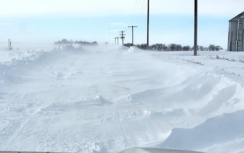 County Road 6 southeast of Aurora is in the process of drifting shut again Monday afternoon after having already been plowed by county highway crews over the weekend. 