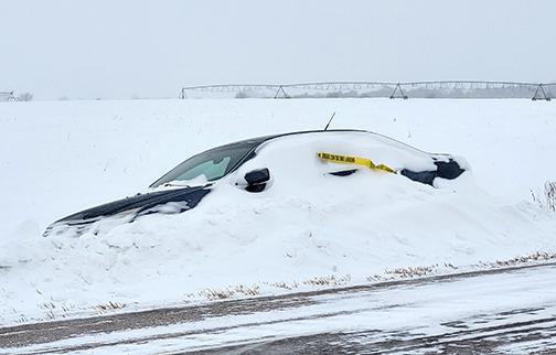 This car seen abandoned along Highway 14 Monday morning about a mile north of the Marquette turnoff was one of more than a dozen vehicles abandoned in the county over the weekend, according to County Highway Superintendent Jeremy Brandt. Their drivers had to be rescued by highway department workers and deputies after they got stuck in the snow.