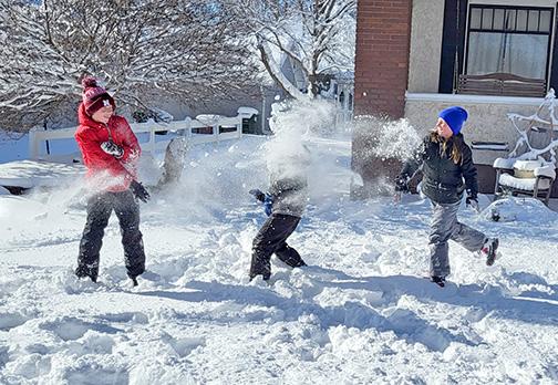  Landon Peterson, center, gets caught in the crossfire in a snowball fight between his sister Lorelei, right, and their friend Hayes Lathrop. The epic battle occurred during the Jan. 9 school Snow Day in Aurora. 