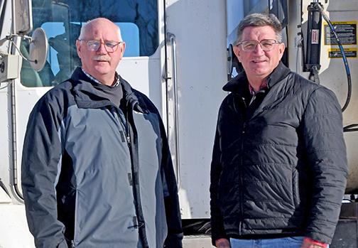 Brothers Dean, left, and Mark Klute stand by one of the two feeding trucks they use in their Triple K Cattle Company cattle feeding operation northeast of Hampton. The company is being honored this week by the York-Hamilton County Cattlemen at their 75th annual banquet in York. 