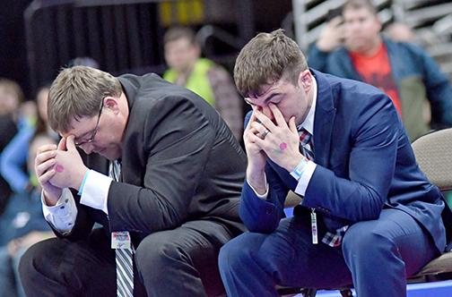 HPC coaches Fred Church (left) and Martin Phillips react as time runs out on Wyatt Urkoski’s finals match, finishing second and seeing his undefeated campaign end with a loss. 