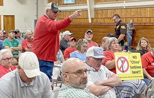 Robert Bernt, a farmer from Spaulding, voiced his displeasure with local officials and wind developers at a public meeting in Greeley County in June. 
