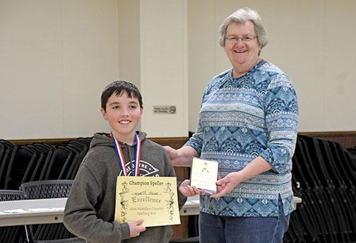 Winning first place in eighth grade and first overall was Wyatt Heiss from Aurora Middle School. Presenting the award is Spelling Bee Coordinator Beth Andrews.