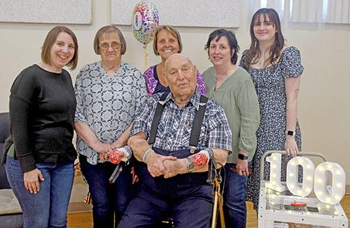 Ramer Fassnacht (center) celebrated his 100th birthday on March 4. Celebrating with him, from left, are his granddaughter, Katie Elder, daughters Joleen Gustafson and Teresa Elder-Smith and granddaughter Lizzy Smith.